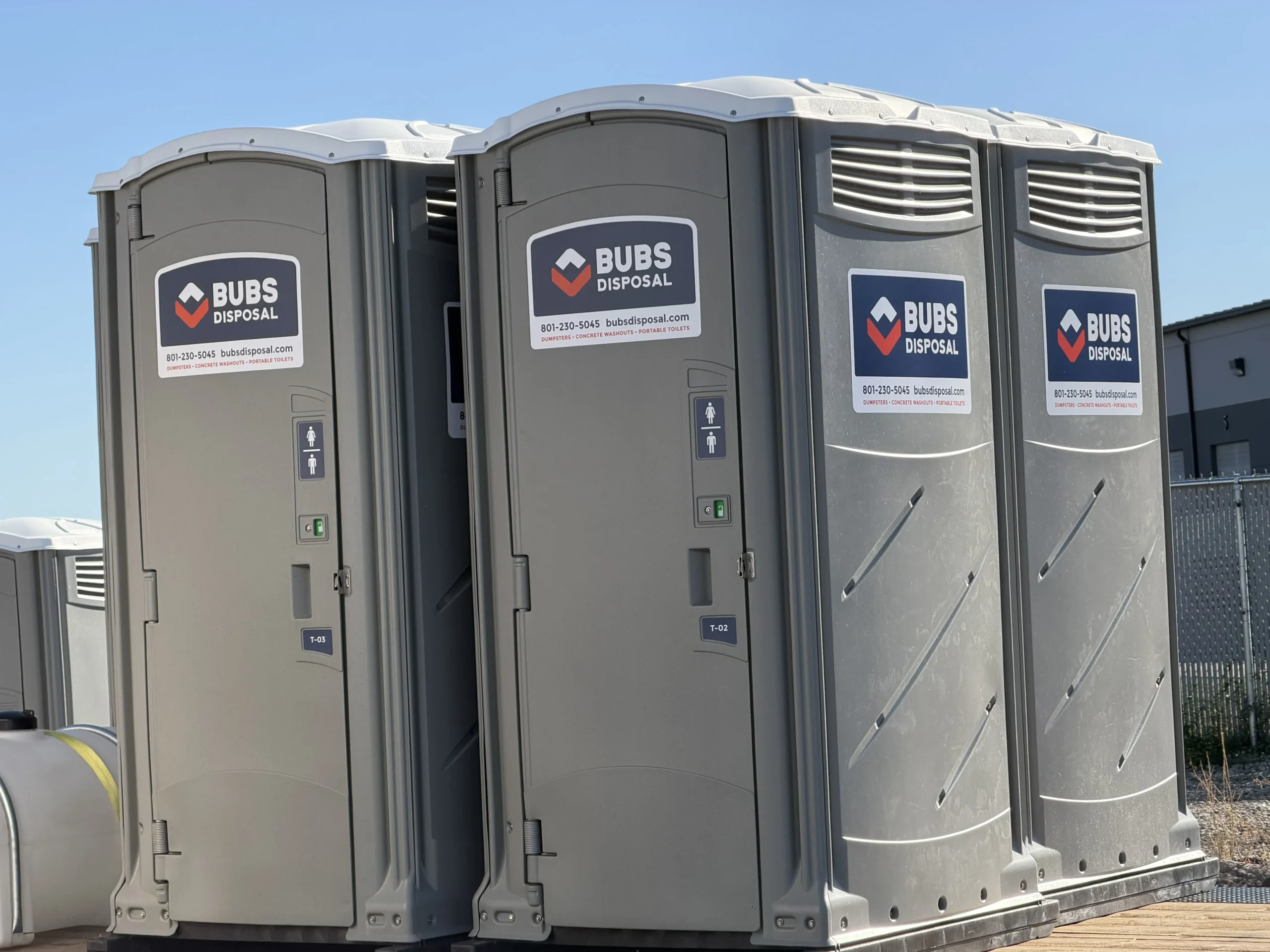 Portable toilets lined up at a long-term jobsite