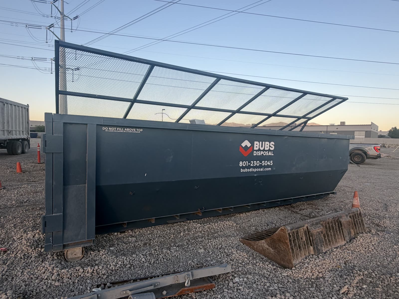 Bubs Disposal 30 yard covered dumpster showing the hinged mesh cover, Utah