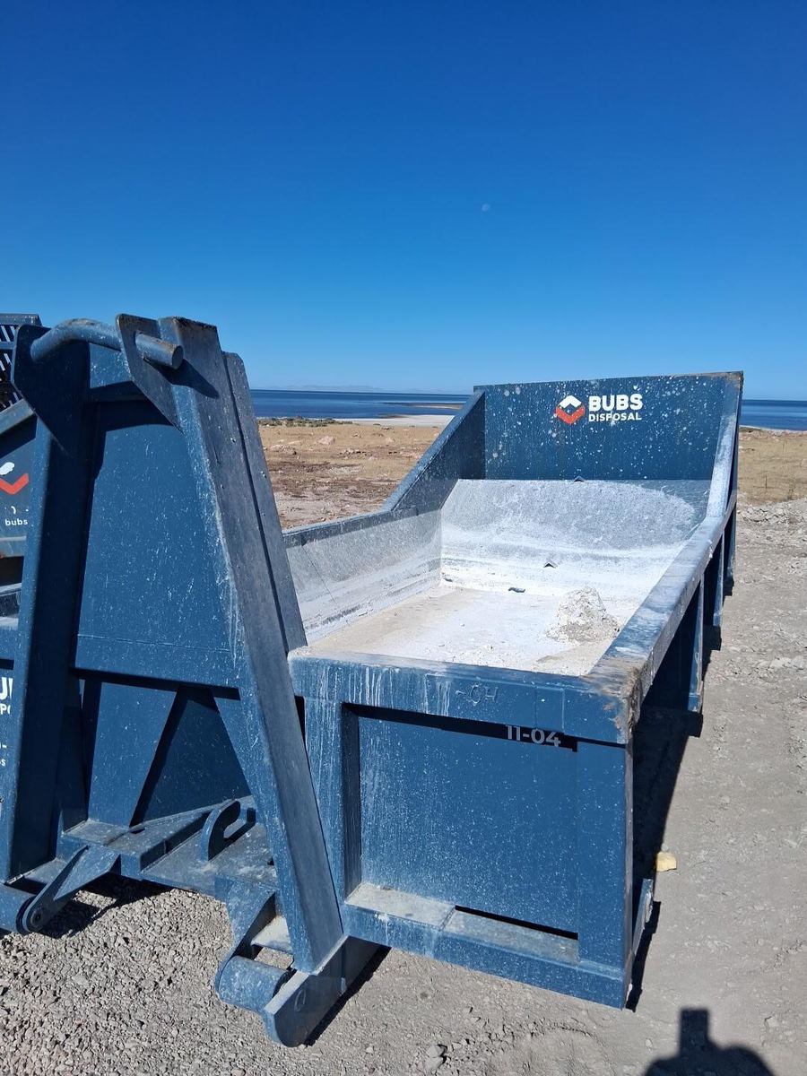 A Bubs Disposal concrete washout set out near the Great Salt Lake under a clear blue sky.